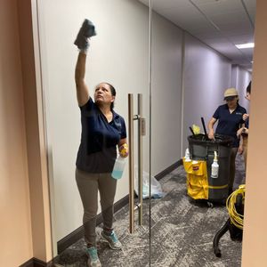 Expert Cleaning Solutions staff members cleaning office building entrance doors