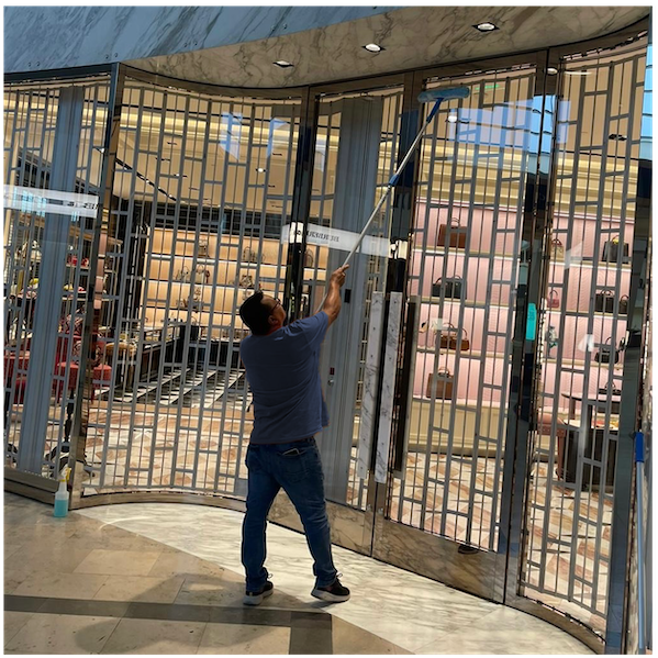 Cleaning retail store windows at the mall